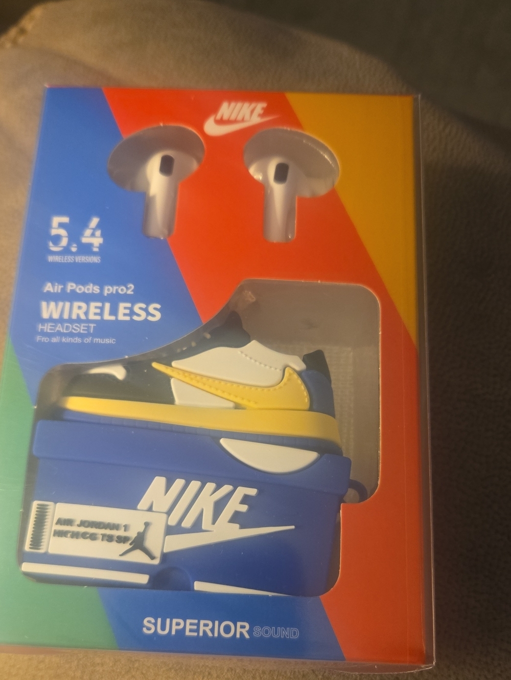 Nike Blue and Yellow Wireless Earbuds with Shoe-Themed Charging Case